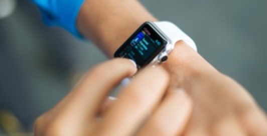 a hand touching an i-watch